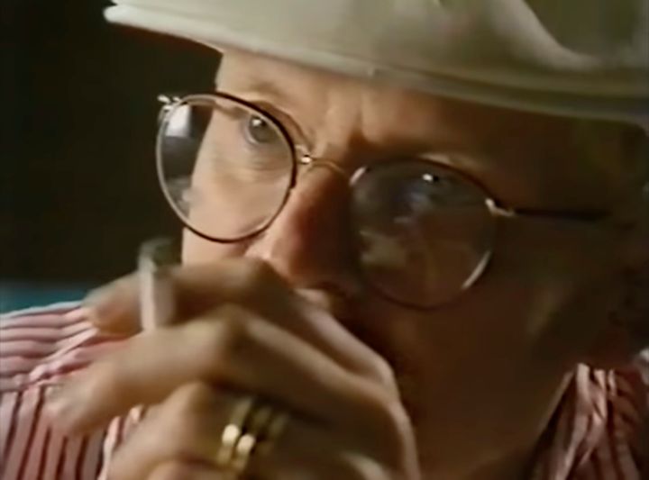 Another screenshot from "Painting with Light" Close-up on David Hockney's eyes, thoughtfully considering the painting screen. His index and ring-finger are close to the camera, obscuring his mouth